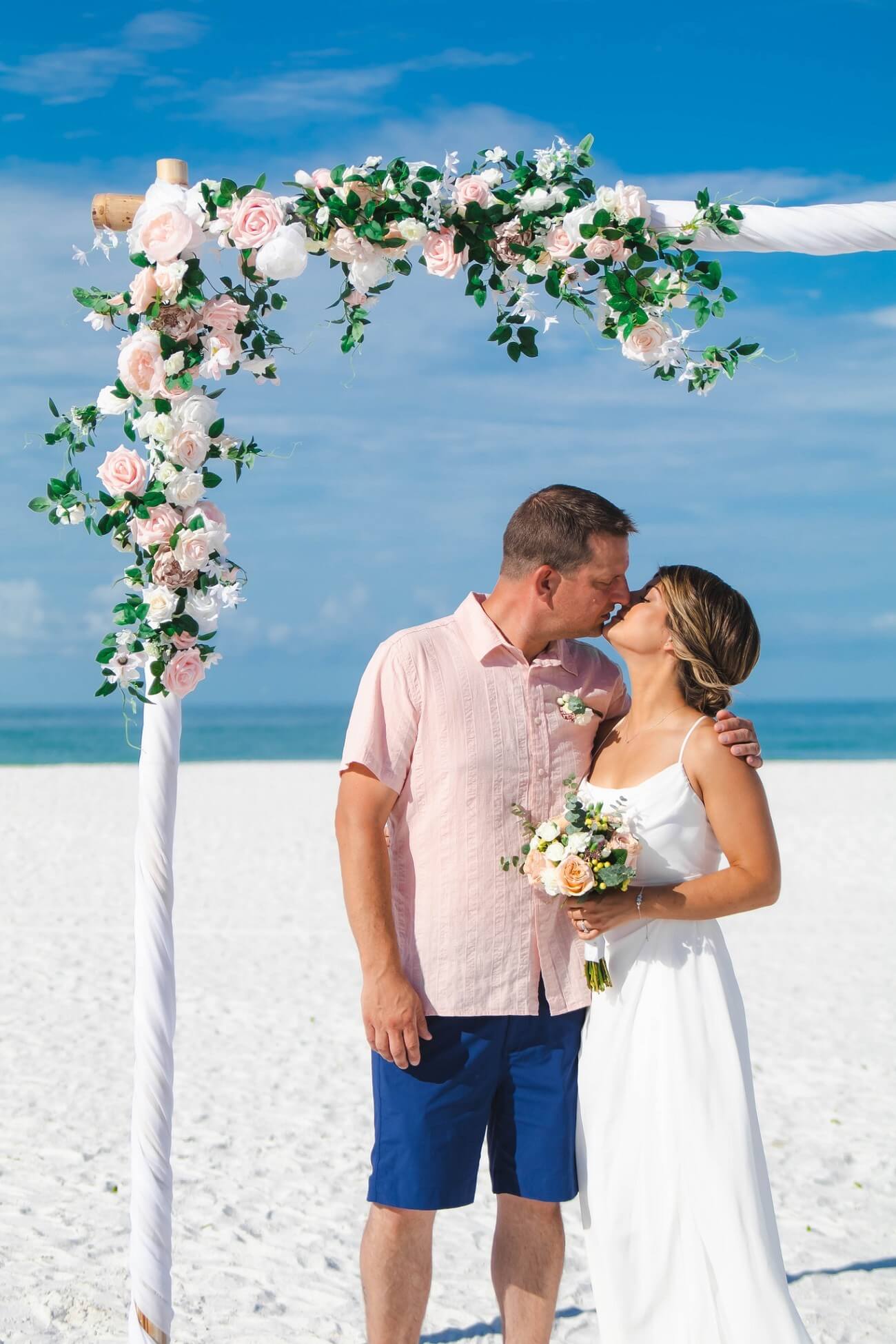 Fresh-flower beach wedding detail at golden hour